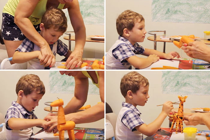 Мама с ребенком делают жирафа из моркови